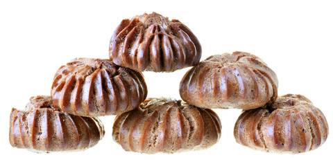 Heap of freshly baked brown eclairs isolated
