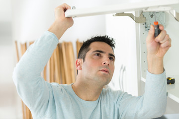 man working on a new kitchen installation