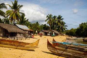 Obraz na płótnie Canvas Priogue on the beach under palms of local fishermen village on Nosy Be, Madagascar