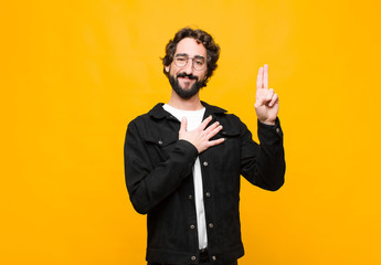 young crazy handsome man looking happy, confident and trustworthy, smiling and showing victory...
