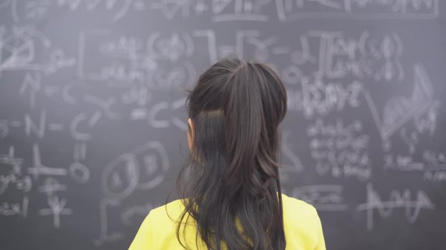 Rear view of a student trying to solve question math