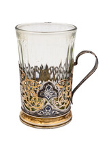 Faceted glass in an old vintage white metal Cup holder. Close up. Isolate on a white background.