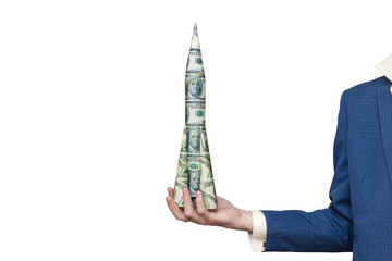 Man in a business suit holds a rocket of paper dollars on an isolated white background. American...