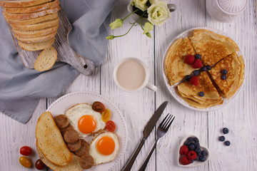 Breakfast with pancakes and fried eggs