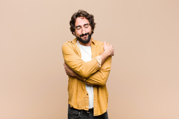 young crazy cool man feeling in love, smiling, cuddling and hugging self, staying single, being...