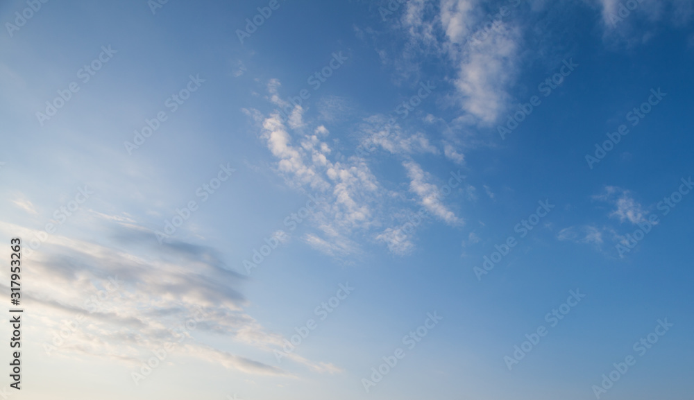 Wall mural blue sky clouds background. beautiful landscape with clouds and orange sun on sky