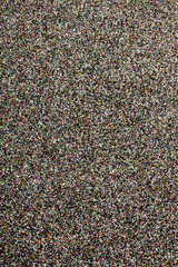 Glitter multi-colored background for your stylish design. Grainy texture in elegant  light tone. High resolution. Macro