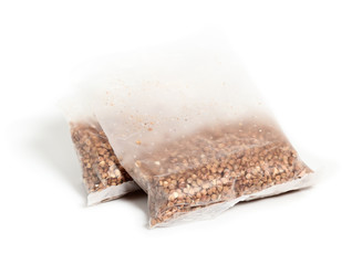 Boil in bag buckwheat groats in polythene sachets (plastic bag). Isolated on a white background.