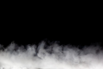 Bright white smoke (fog, vapor) on a dark black background, making up intricate beautiful patterns. A stripe of fog on the bottom edge, the other is darkness