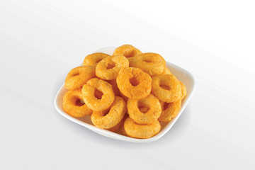 Pile of crispy Masala Corn ring, Cream & Chilli snack (Fryums - Frymus) in white dish isolated on white background, Sweet brekfast cereal rings - Image
