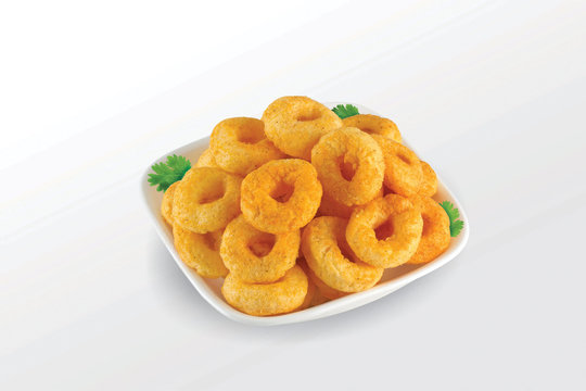 Pile of crispy Masala Corn ring, Cream & Chilli snack (Fryums - Frymus) in white dish isolated on white background, Sweet brekfast cereal rings - Image