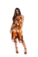 Well-dressed model portrait of smiling girl in casual pretty clothes.  Brunette lovely lady on white background. Happiness, positivity and fashion