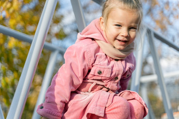 little girl in a pink coat  smile