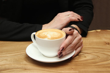 Female hands with a cup of coffee