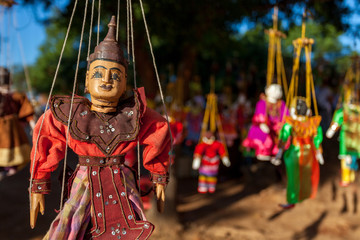 Wooden Puppet On Strings Hanging On a Tree