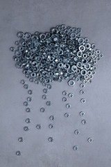 Shape cloud with rain made of metal nuts (screw)
