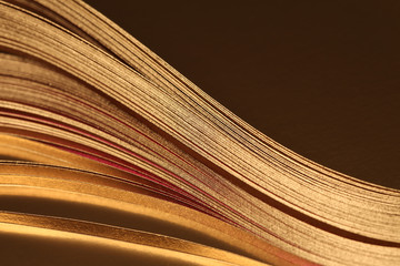 Abstract backgound. Gold (bronze) paper wave on black.