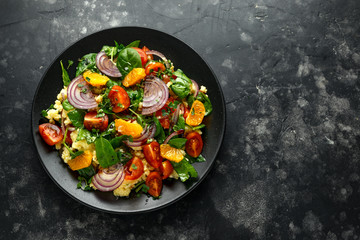 Vegetable Millet salad with red onion, cherry tomatoes, spinach, tangerine and clementine dressing....