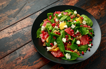 Orange Grapefruit salad with spinach, walnuts, pomegranate seeds and feta cheese. healthy food