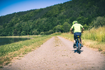 man riding a bike on country road