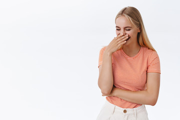 Girl chuckling and silly cover mouth, look away as laughing out loud from funny joke, blushing...