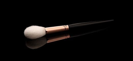 makeup brush on black ground