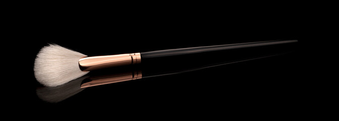 makeup brush on black ground