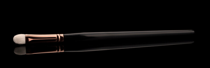 makeup brush on black ground