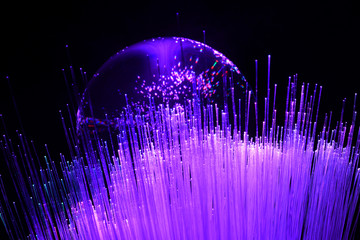 abstract background with colored fibers optics reflected on glass sphere