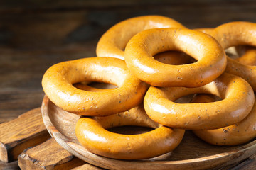 Bagels on a wooden plate on a brown wooden table. Rustic style. Homemade cake
