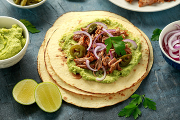 Mexican Corn tortilla with shredded Pork, avocado, red onion and jalapeno