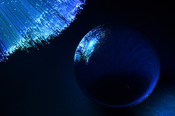 abstract background with colored fibers optics reflected on glass sphere