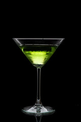 martini glass and splash from falling ice on a black background