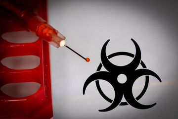 Syringe with blood droplet and biohazard sign - obrazy, fototapety, plakaty