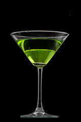 martini glass and splash from falling ice on a black background