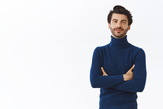 Serious-looking confident caucasian bearded businessman in high neck sweater, cross arms over chest, self-assured, assertive pose, smirk and looking camera determined, white background