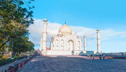 Unidentified people walk around Taj Mahal. Taj Mahal was designated as a UNESCO World Heritage Site...
