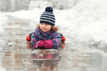 girl lies in a winter pool in the middle of snowdrifts