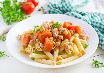 Italian pasta, penne with minced meat, chickpeas and pumpkin. Healthy food. Pasta with forcemeat.