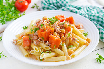 Italian pasta, penne with minced meat, chickpeas and pumpkin. Healthy food. Pasta with forcemeat.
