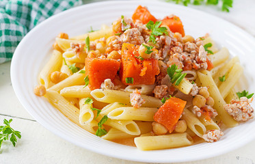 Italian pasta, penne with minced meat, chickpeas and pumpkin. Healthy food. Pasta with forcemeat.