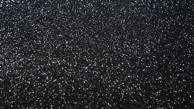 Video background black with silver glitter.