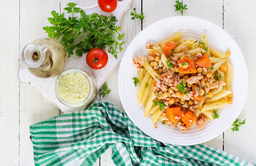 Italian pasta, penne with minced meat, chickpeas and pumpkin. Healthy food. Pasta with forcemeat. Top view, overhead