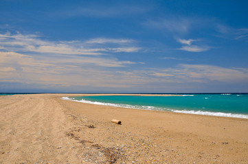 Sandy beach on the azure sea coast