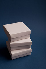 Stack of white cardboard boxes on a classic blue background