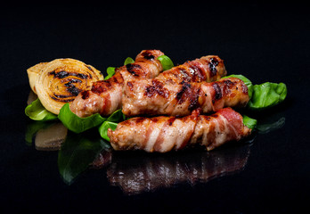 Meat rolls on a black background..