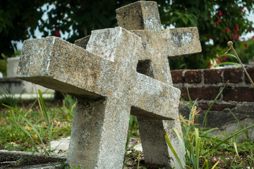 Couple of old gravestones in christian cemetery leaning together as symbol of eternal love