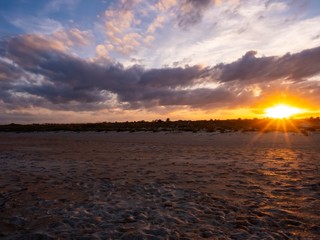 Fototapeta na wymiar Sandy St. Augustine Florida Beach with Cloudy Colorful Sky at Sunset