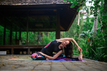 Yoga practice and meditation in nature. Woman practicing near river
