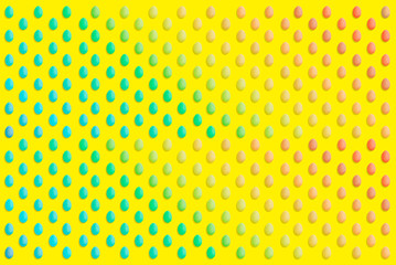 Colorful Easter eggs on yellow background.